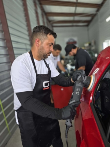 man aplying ceramic coathing to a car